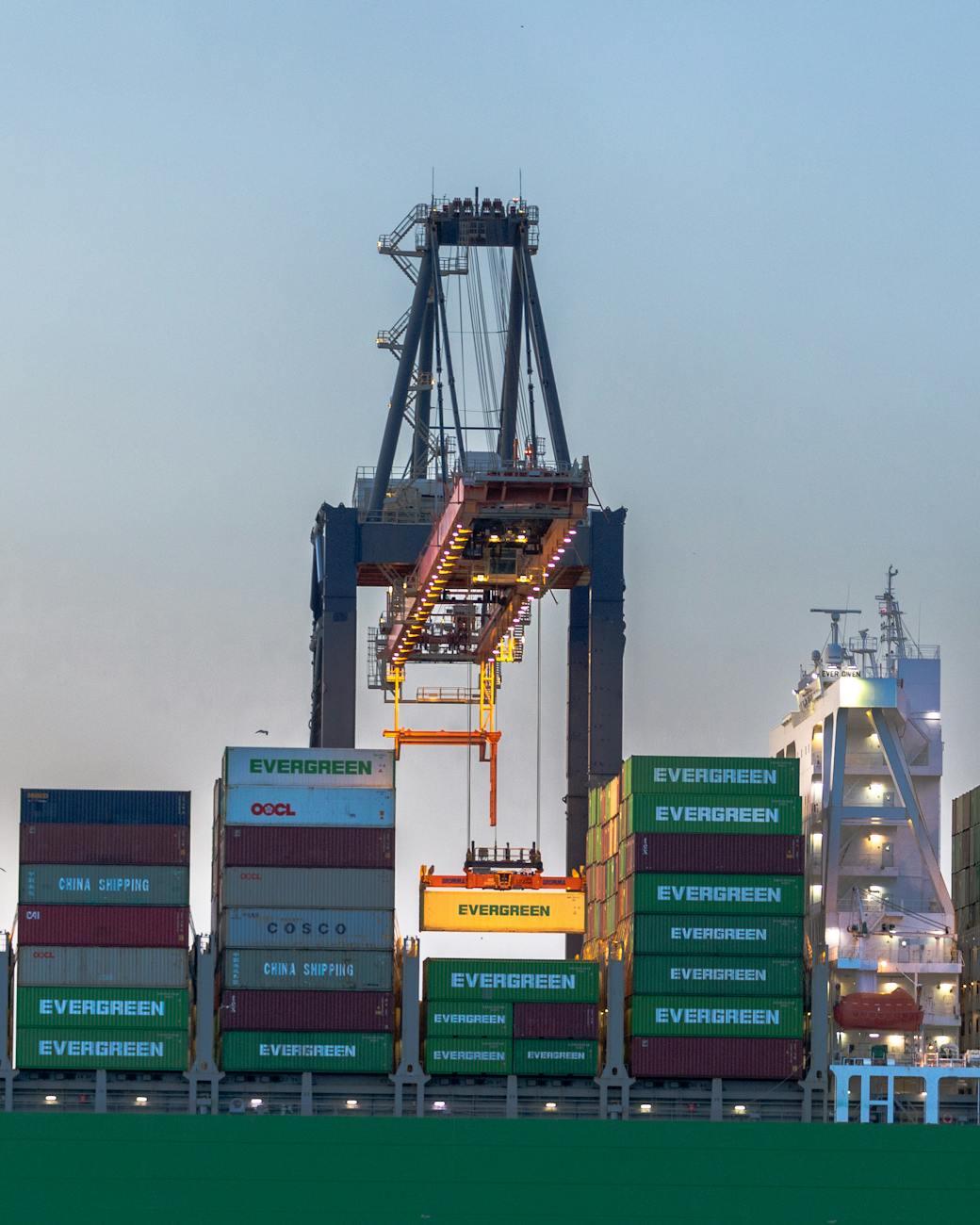 container crane in rotterdam port at dusk